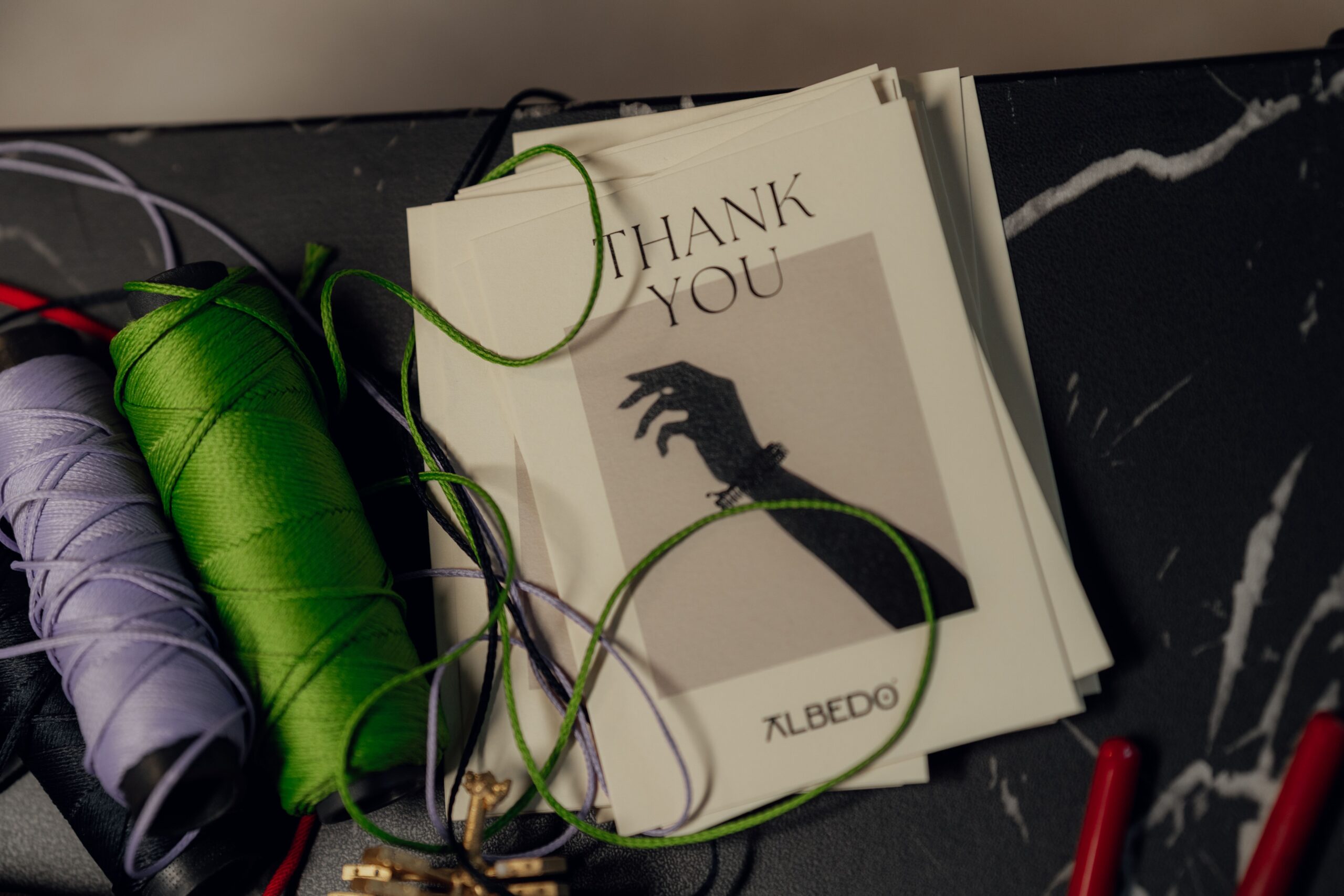 Flat lay of colorful craft supplies and thank-you cards for handmade papercraft projects